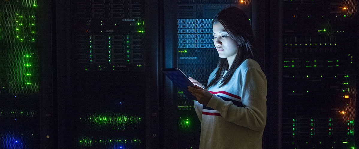 Young-woman-working-on-digital-tablet-in-server-room_1198x500