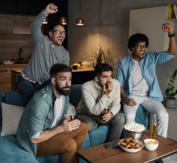 A group of friends watching a match on TV