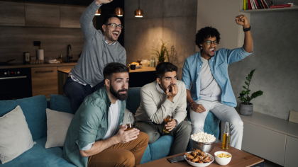 A group of friends watching a match on TV