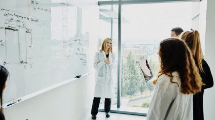 A scientist leading a discussion on Open Science with colleagues in a laboratory.