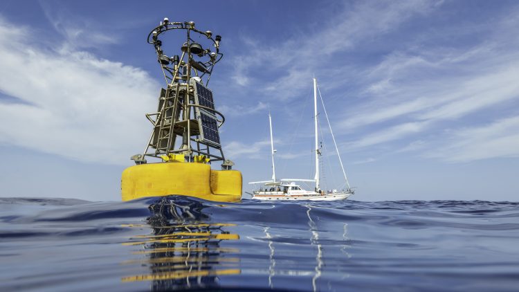 A boat next to an ocean buoy