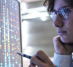 An analyst looks at data on a screen