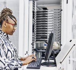Une informaticienne configure un serveur dans un datacenter
