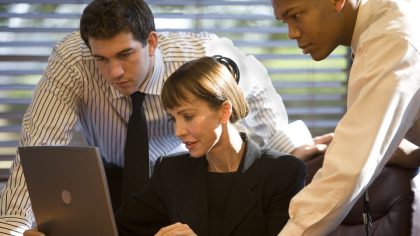 Getty Images - A photo of three businesspeople working together in front of a laptop computer.