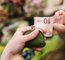 A person handles a ten euro banknote