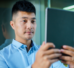 A man having his face scanned by a tablet for better audiovisual recognition