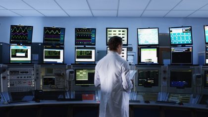 Scientist monitoring computers in control room